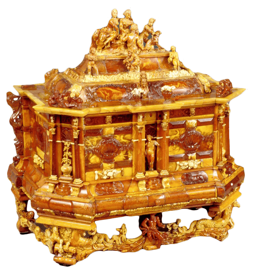Ornate amber and gilded cabinet with sculpted figures, decorative base, photographed on white background.